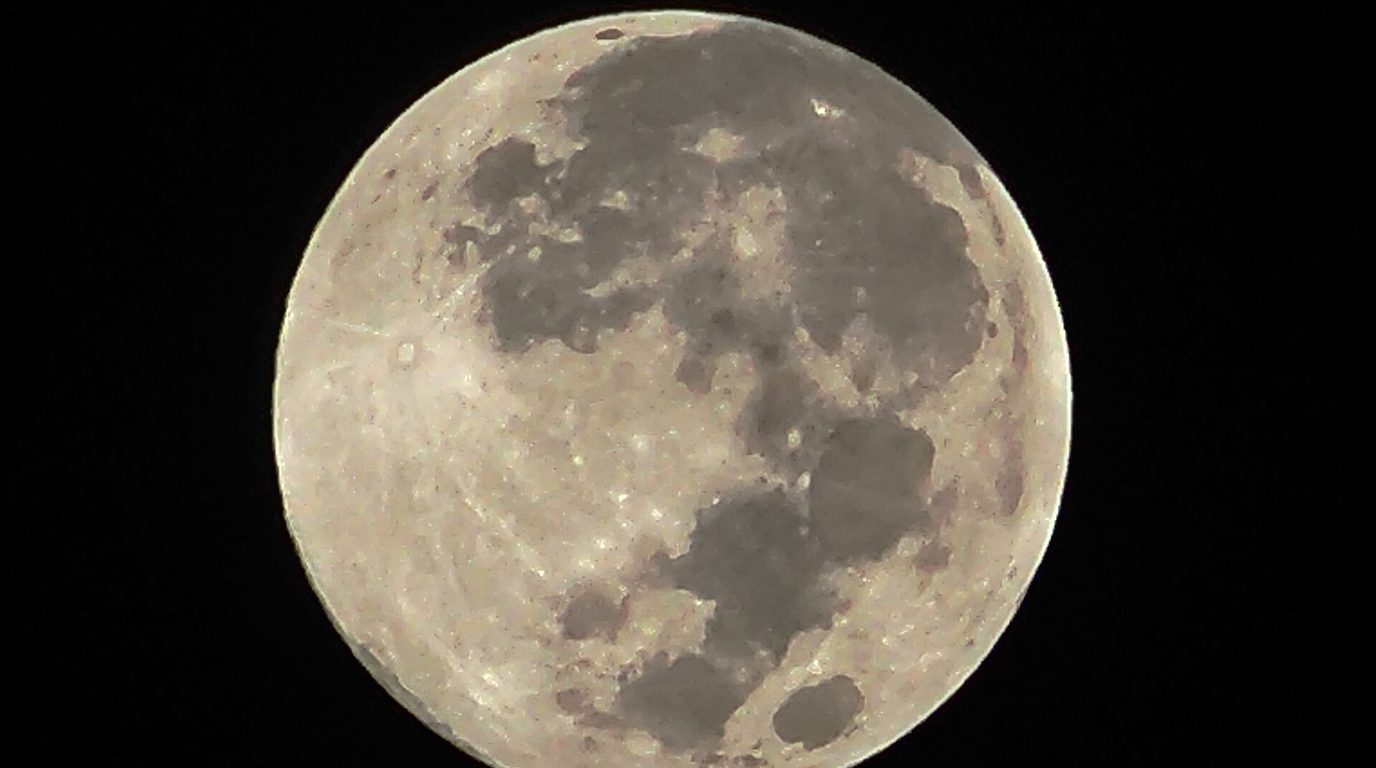 The full moon glowing in a dark night sky — the nights when people measurably sleep less